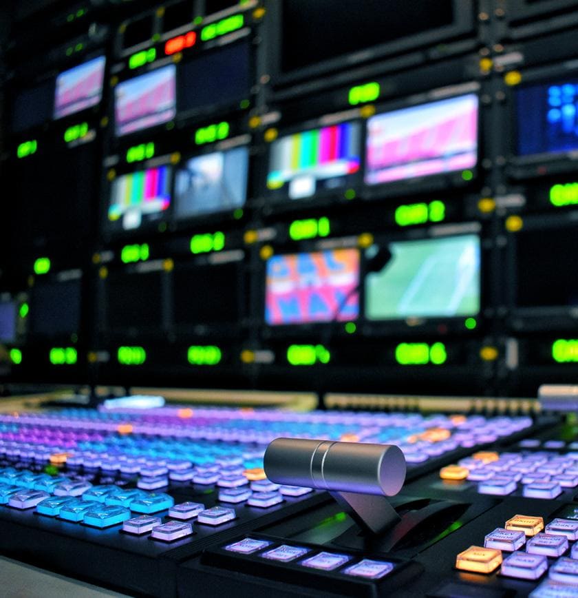 A look at a TV control room with many colorful buttons.