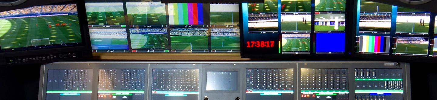 mutiviewer screens in a broadcast booth showing test patterns and a sports field