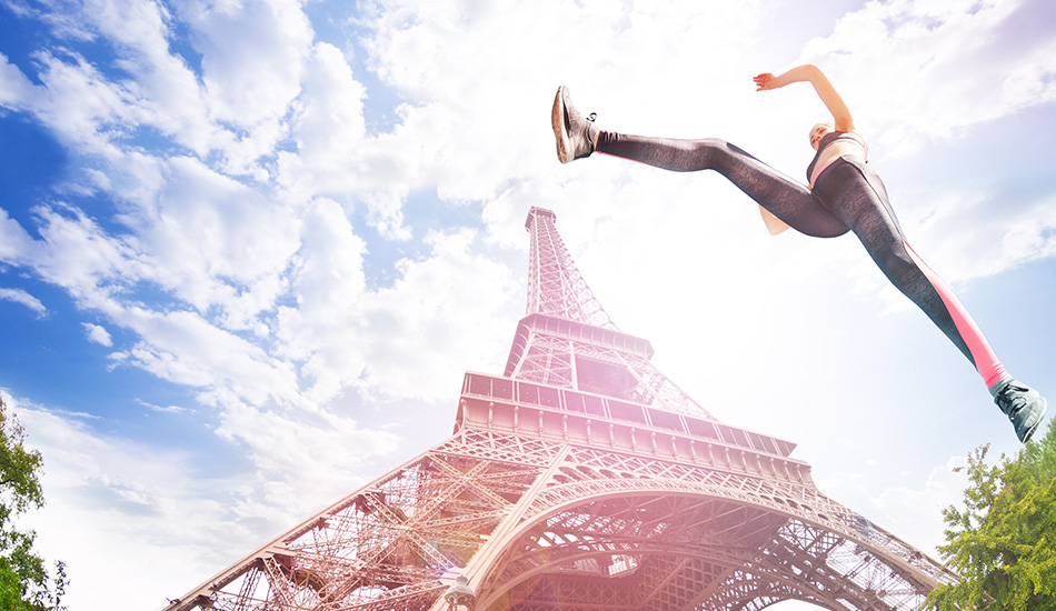 Track runner jumping with Eiffel Tower in background